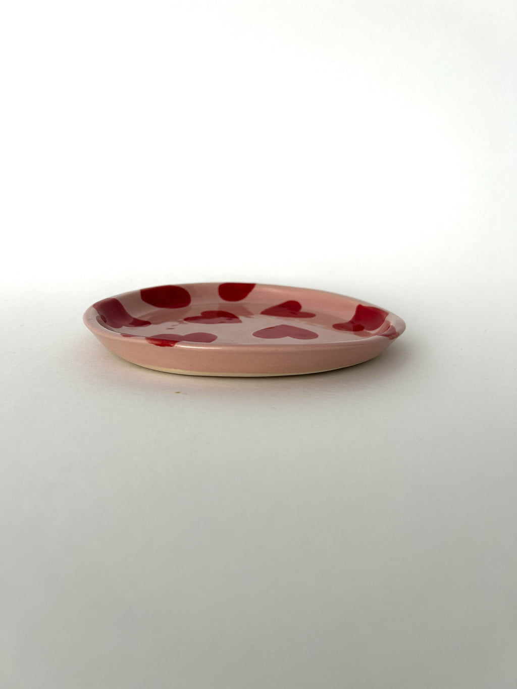 Handmade ceramic plate with smileys in red hearts